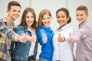 a group of teenagers showing thumbs up